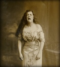A portrait of a woman from around the turn of the century. This photo may have been taken mid-sneeze. i hope i am immortalized in this manner
