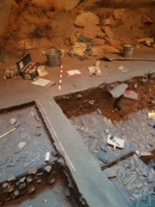 A replica archaeological dig at the base of the indoor cliff.
